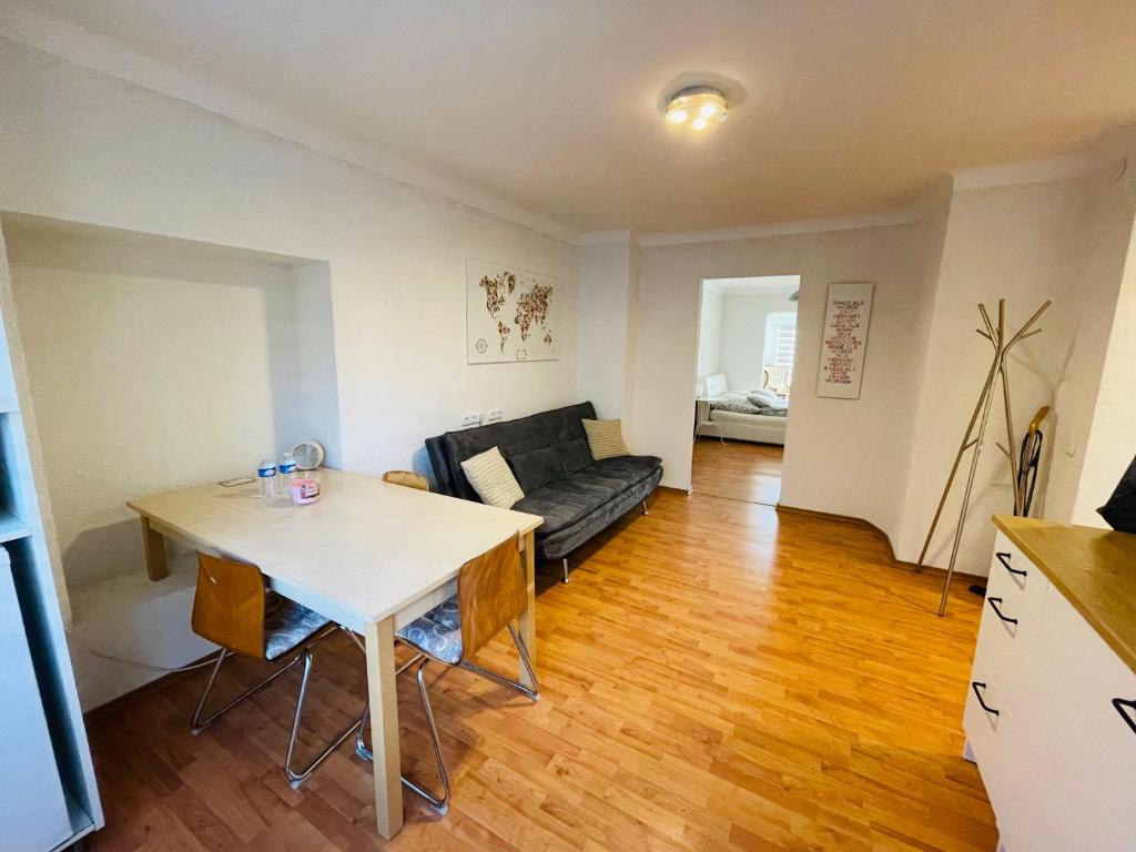 a living room with a table and a couch at Apartment Marielena in Püttlingen