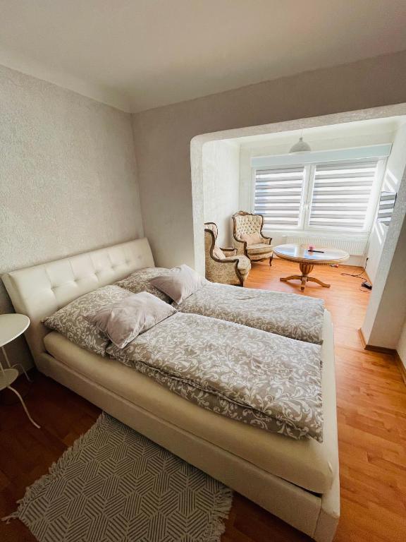 a bedroom with a bed and a table and chairs at Apartment Marielena in Püttlingen