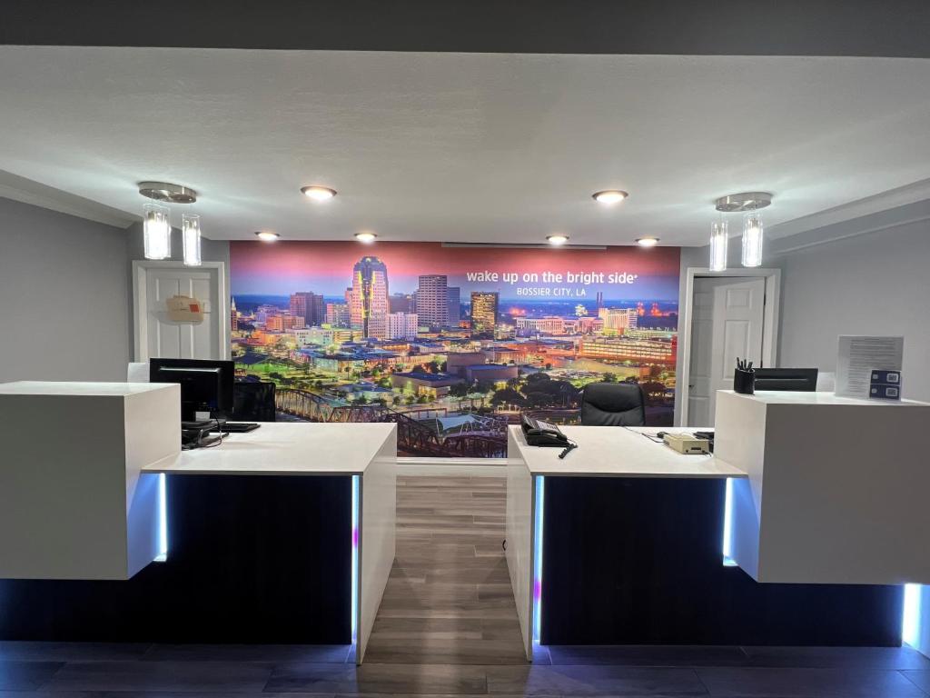 an office with a large mural of a city at La Quinta Inn by Wyndham Bossier City in Bossier City