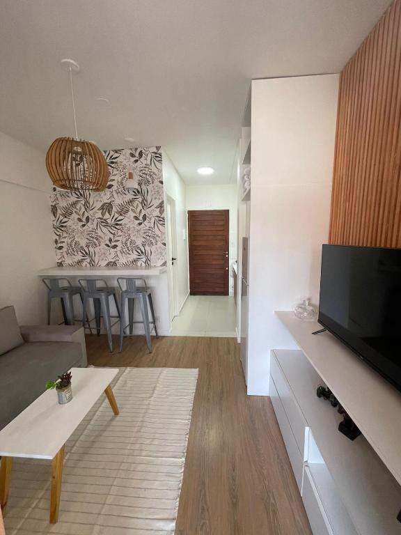 a living room with a couch and a tv and a kitchen at Obelisco Haus in Buenos Aires