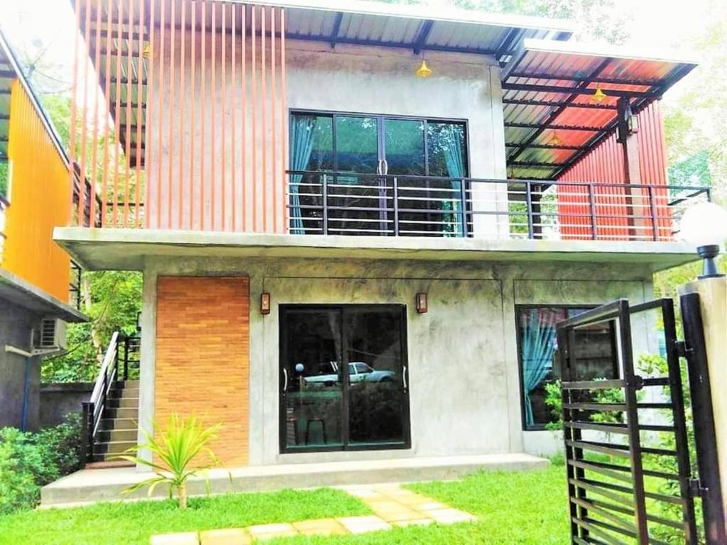 a house with a balcony on top of it at K home lanta villas in Ko Bu Bu