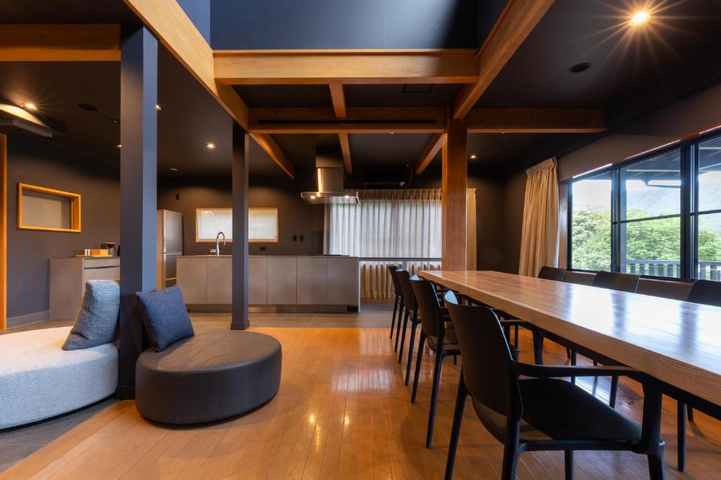 a dining room with a long table and chairs at Kawaguchiko Country Cottage Ban in Fujikawaguchiko