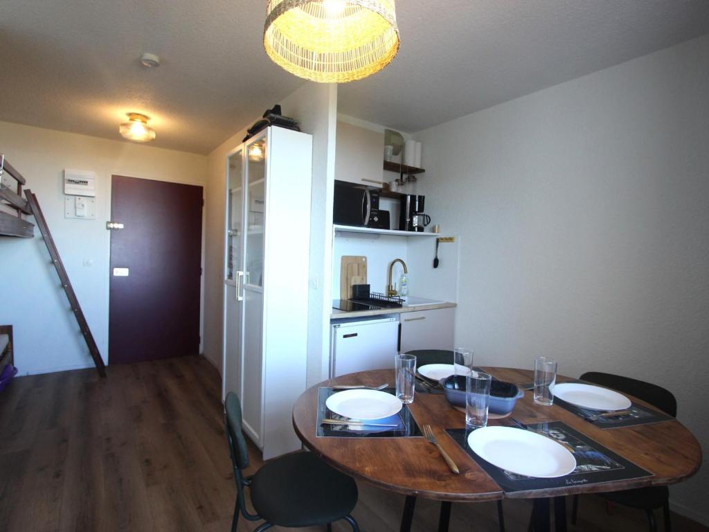 a dining room table and chairs in a kitchen at Studio confortable à Chamrousse avec balcon et cuisine équipée - FR-1-340-283 in Chamrousse