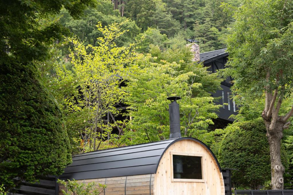 a building with a chimney on top of it at Kawaguchiko Country Cottage Ban in Fujikawaguchiko