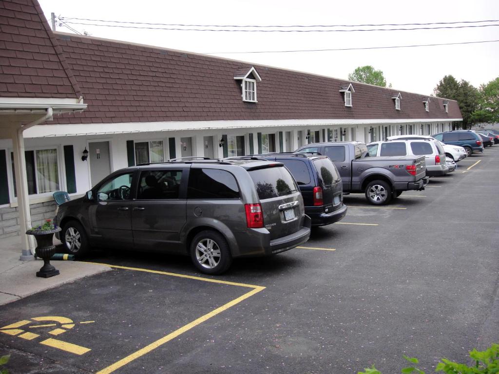 a row of cars parked in a parking lot at Country Squire Motel in Arnprior