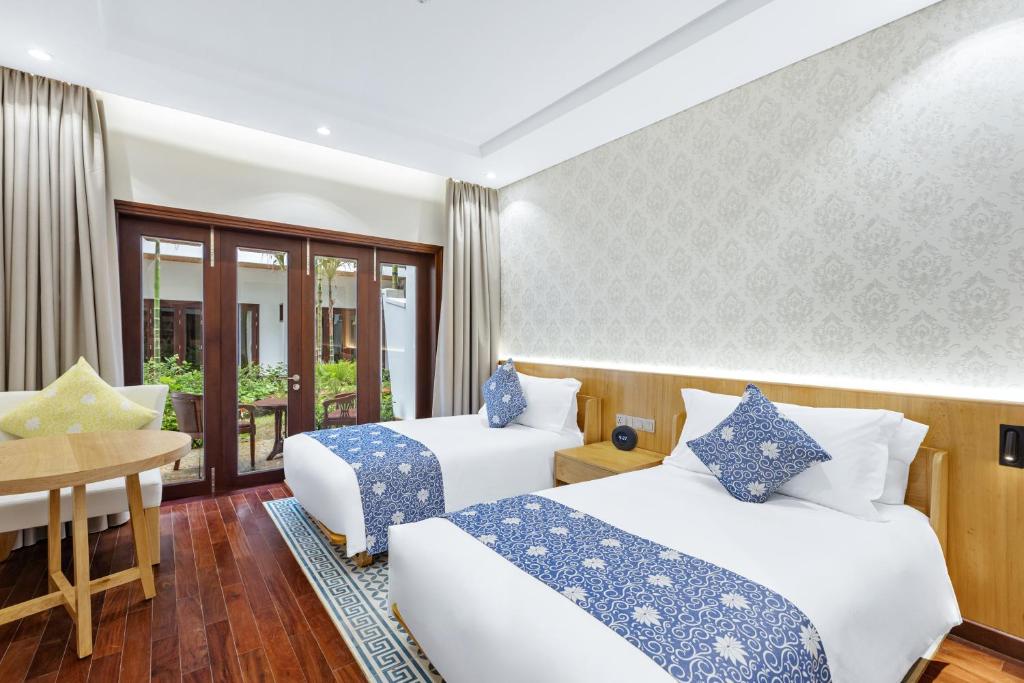 Postel nebo postele na pokoji v ubytování Wafaifo Resort Hoi An