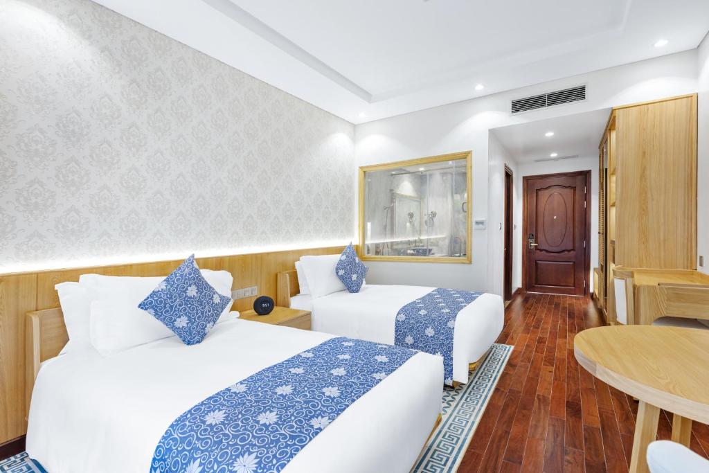 Postel nebo postele na pokoji v ubytování Wafaifo Resort Hoi An