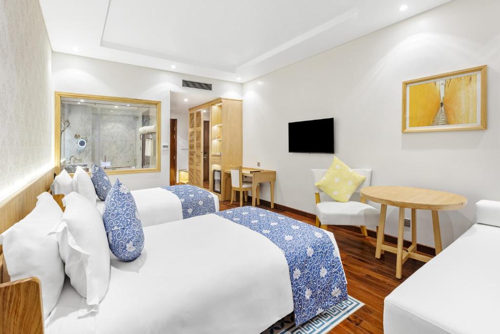 Postel nebo postele na pokoji v ubytování Wafaifo Resort Hoi An