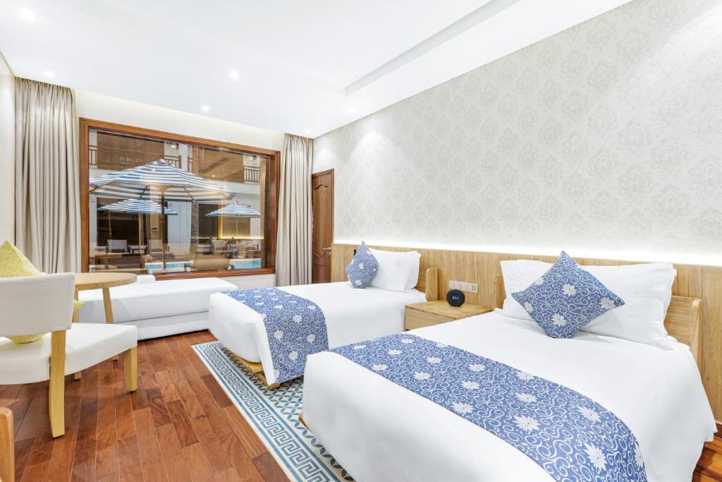 Postel nebo postele na pokoji v ubytování Wafaifo Resort Hoi An