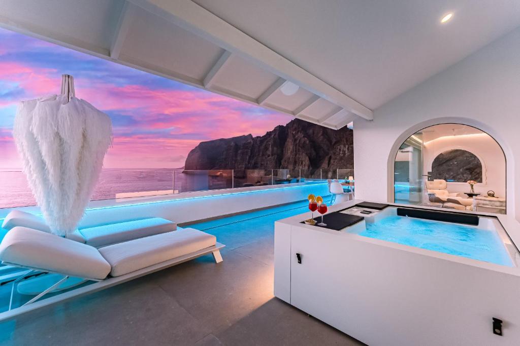 a villa with a infinity pool and a wellness room at Blue Haven - Ocean View Penthouse with private jacuzzi and community pool in Acantilado de los Gigantes