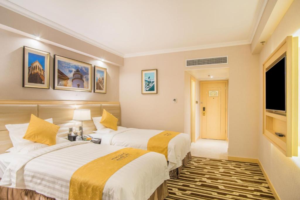 Postel nebo postele na pokoji v ubytování Metropark Hotel Macau
