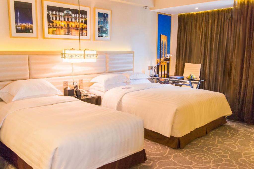 Postel nebo postele na pokoji v ubytování Metropark Hotel Macau