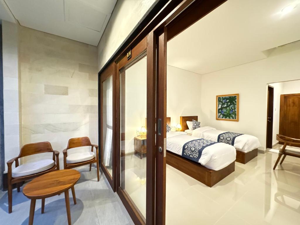 Postel nebo postele na pokoji v ubytování Puri Teduh Guesthouse Ubud