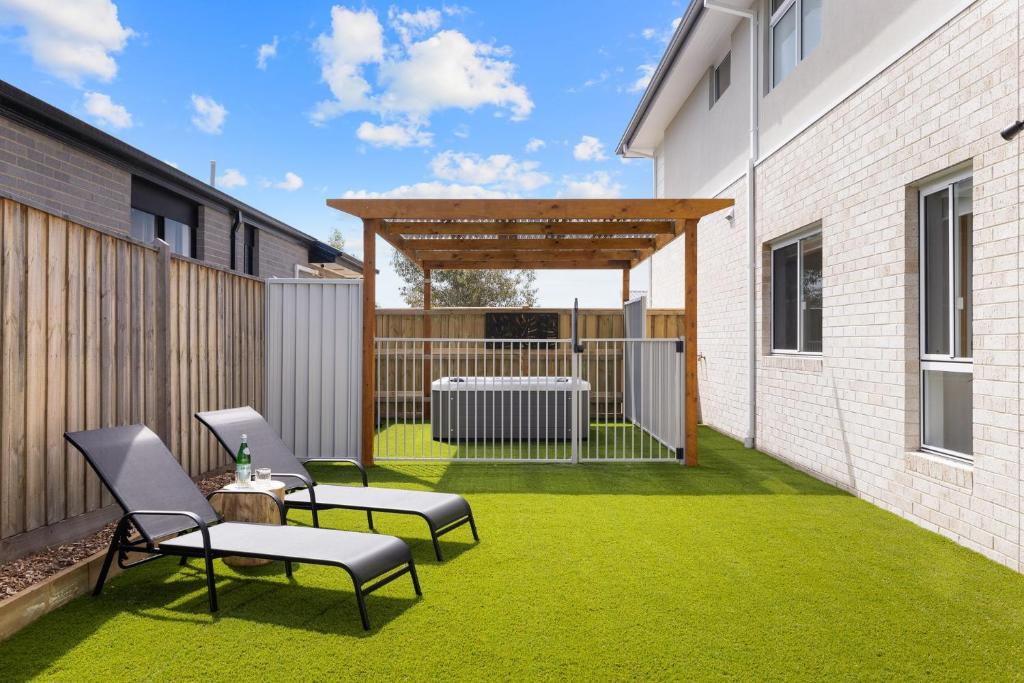a patio with two chairs and a table on grass at SaltCove in Cowes