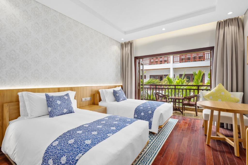 Postel nebo postele na pokoji v ubytování Wafaifo Resort Hoi An