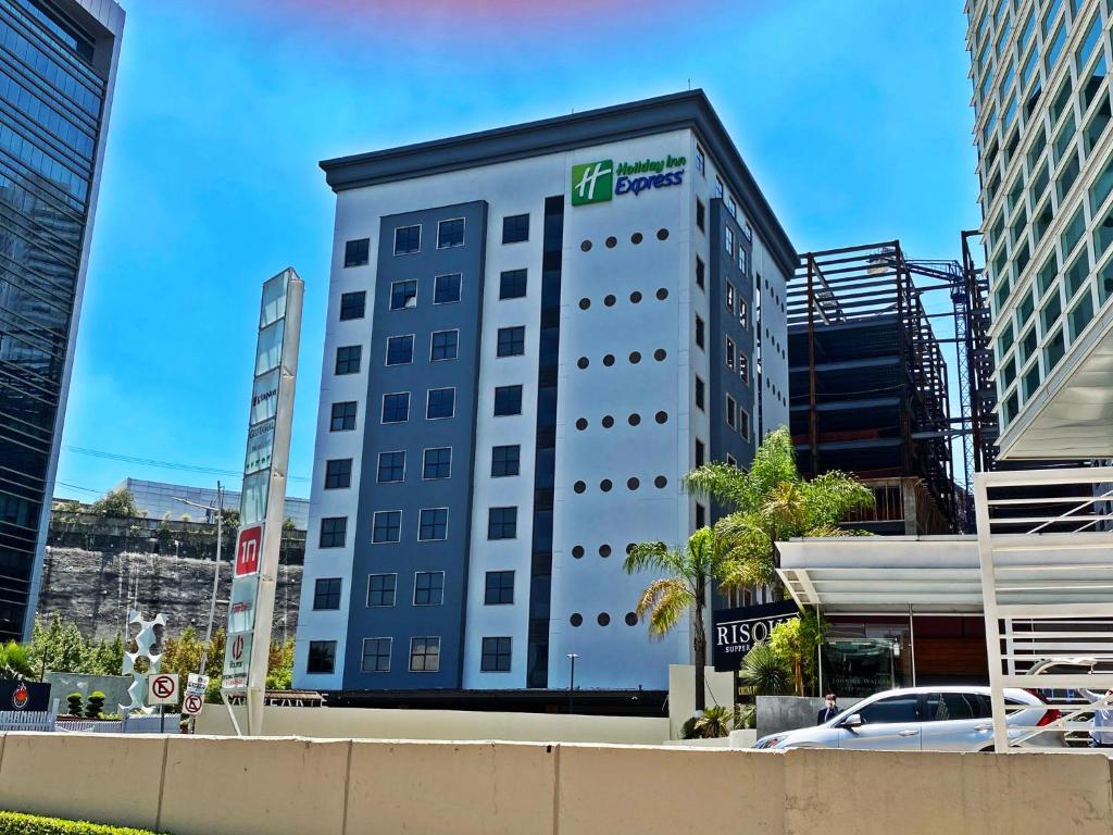a tall white building with a sign on it at Holiday Inn Express Mexico Santa Fe by IHG in Mexico City