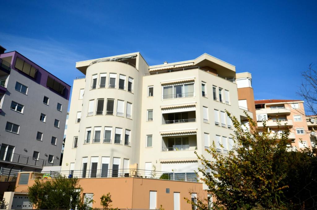 a white building in front of some buildings at Apartments Mariot in Split
