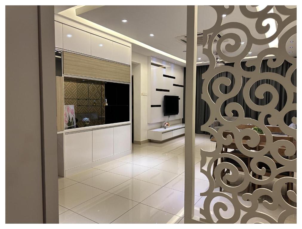 a bathroom with a sliding glass door with a television at Setapak Central Premium Suites in Kuala Lumpur