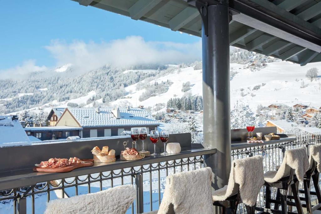 a balcony with a view of a snowy mountain at Grand Hotel Soleil d'Or in Megève