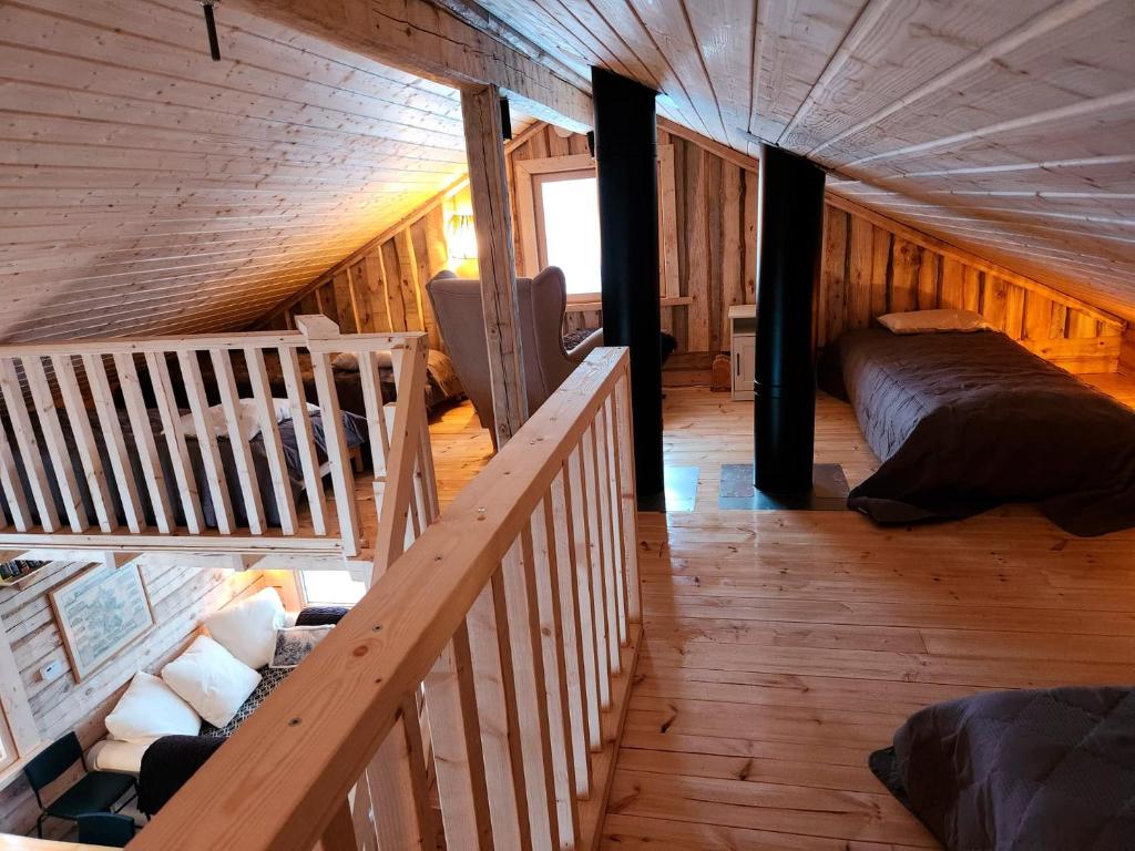 an overhead view of a bedroom in a log cabin at Lapland Riverside Cabin, Äkäsjoki Hideaway - Riverview, Traditional Sauna, Avanto, WiFi, Ski, Ylläs in Äkäsjoensuu