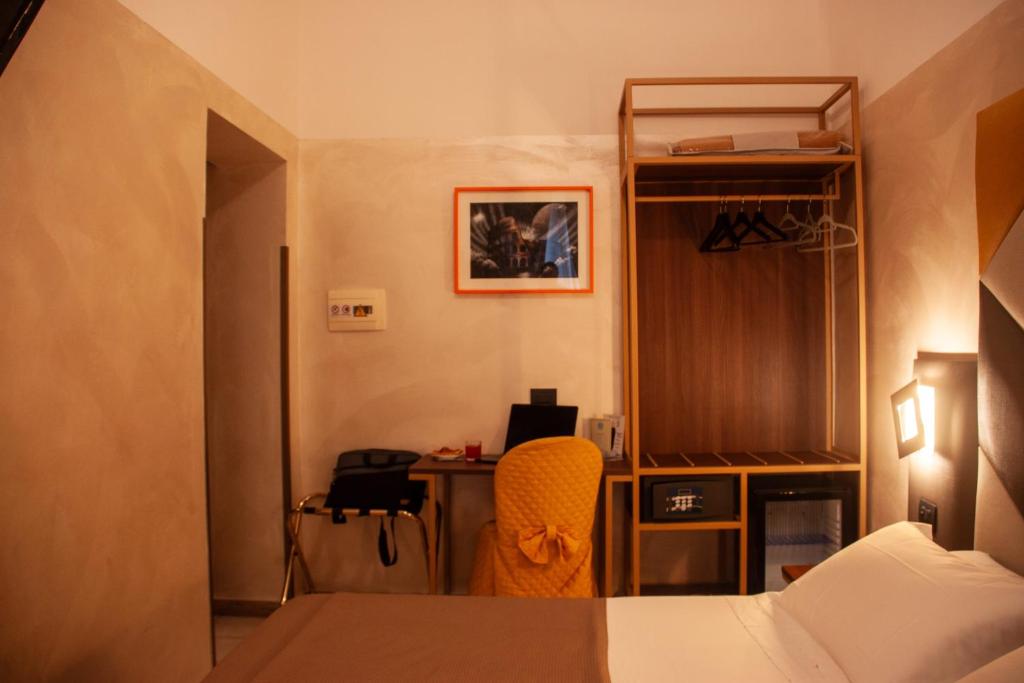 Postel nebo postele na pokoji v ubytování Hotel Assisi