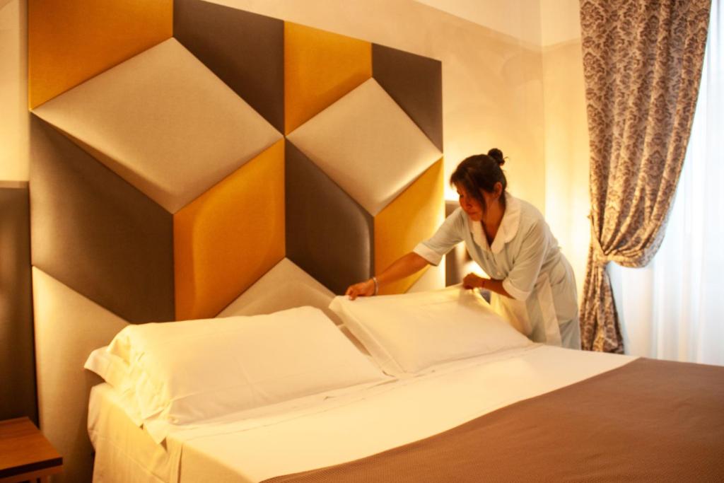 Postel nebo postele na pokoji v ubytování Hotel Assisi