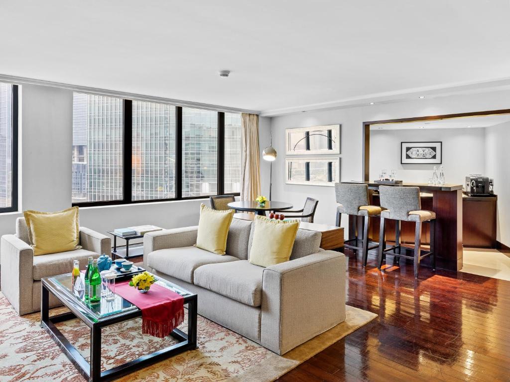 a living room with a couch and a table at Mandarin Oriental, Jakarta in Jakarta