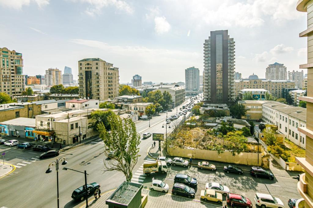 une rue de la ville avec des voitures garées sur un parking dans l'établissement Sil, à Baku