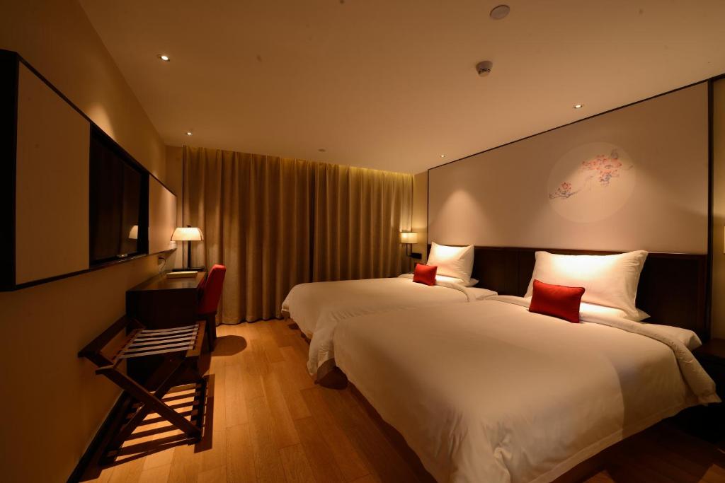 Postel nebo postele na pokoji v ubytování Guangzhou City Join Hotel Shipai Qiao metro Branch