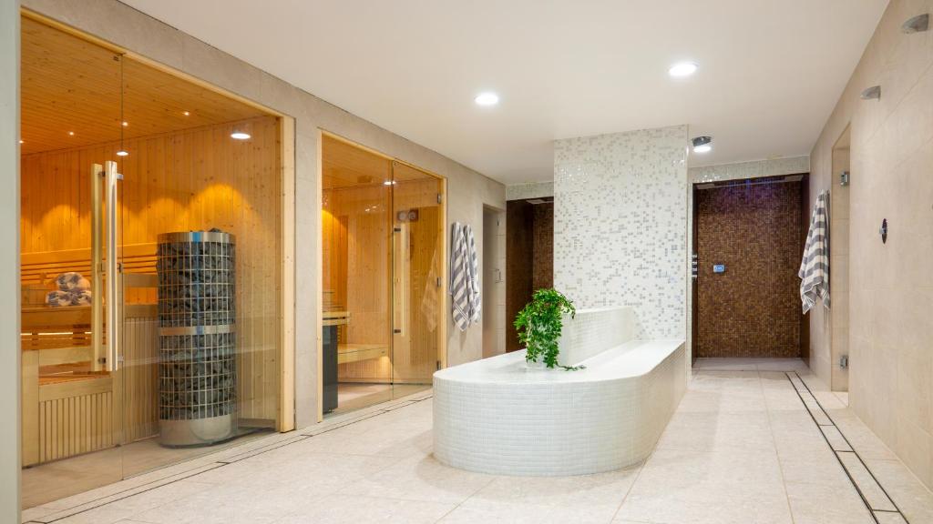 a lobby with a potted plant in the middle of a building at St Moritz Hotel and Cowshed Spa in Polzeath