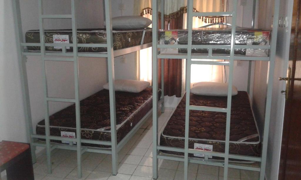 two sets of bunk beds in a room at Pondok Heras Suite in Jakarta