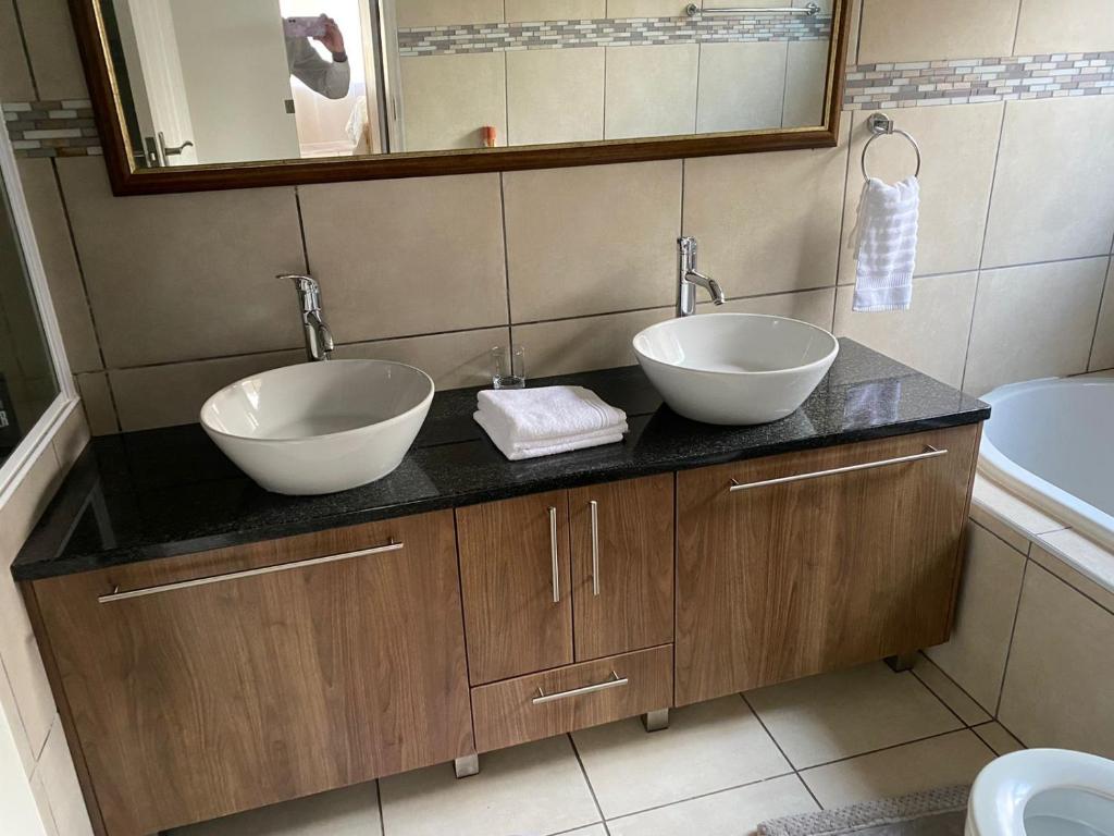 two sinks on a counter in a bathroom at 16 on Swallow in East London