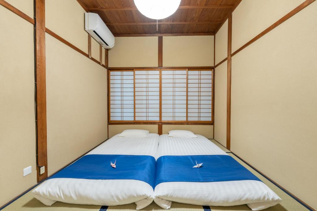 Postel nebo postele na pokoji v ubytování お宿一の華