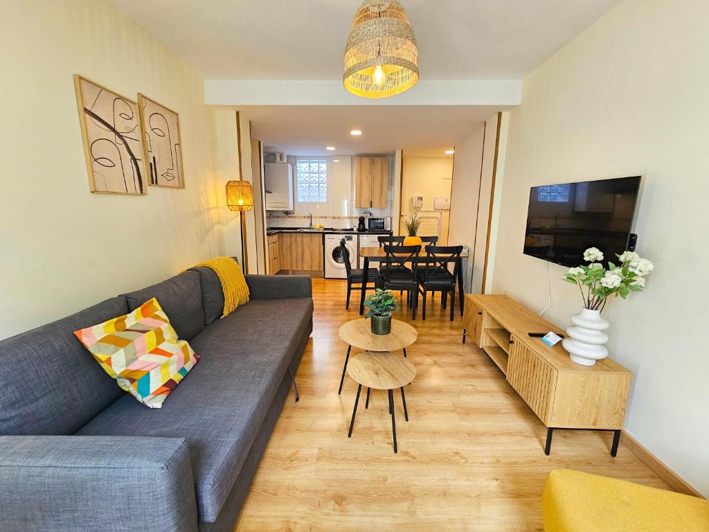 a living room with a couch and a table at Apartamentos Escarrilla Suites 3000 in Escarrilla