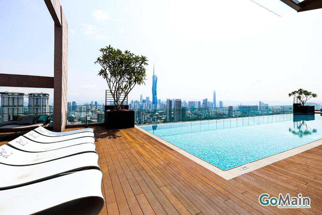 a swimming pool on the roof of a building at 24h Check in & SkyPool- KL Sentral Suite Riveria City Near KL Sentral KL KLCC in Kuala Lumpur