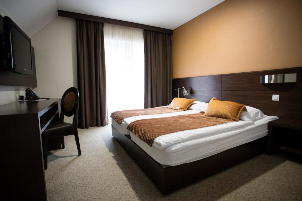 Postel nebo postele na pokoji v ubytování Hotel Mangart