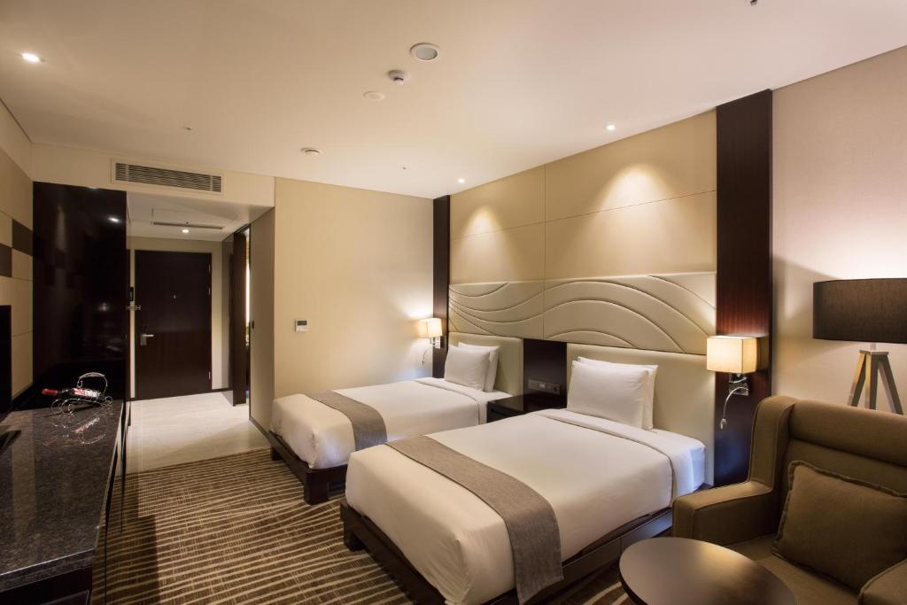Postel nebo postele na pokoji v ubytování I Square Hotel