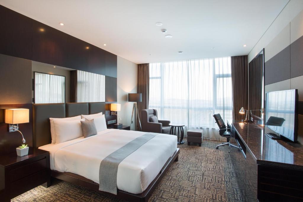 Postel nebo postele na pokoji v ubytování I Square Hotel