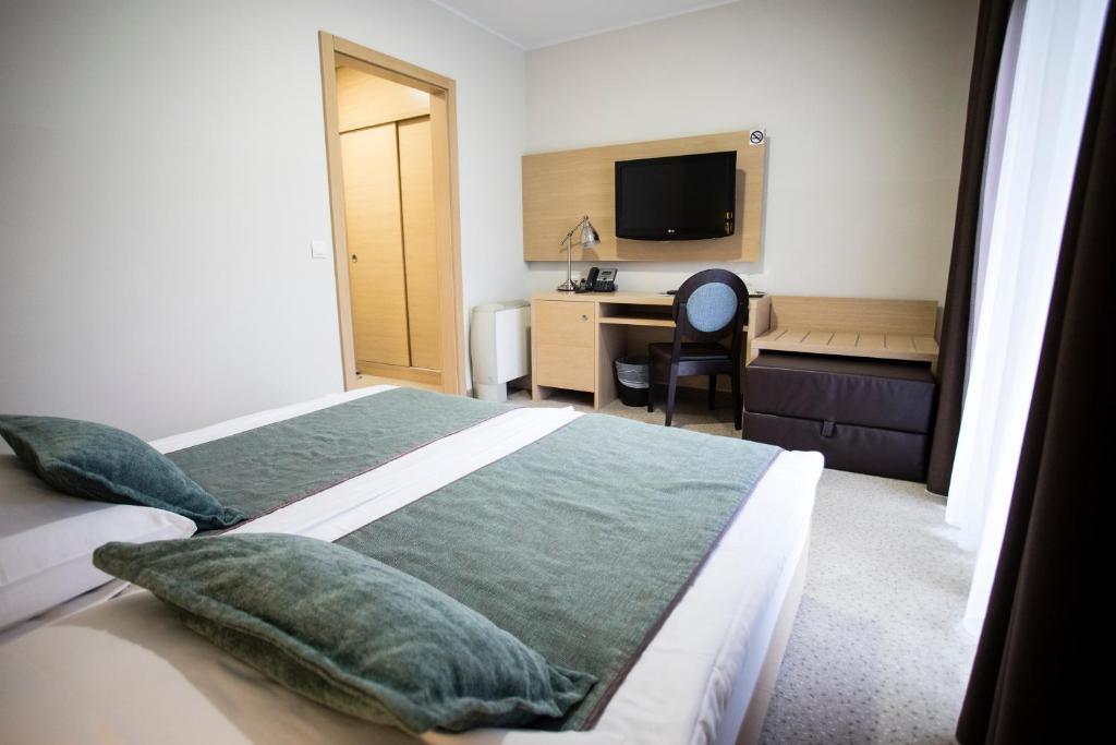 Postel nebo postele na pokoji v ubytování Hotel Mangart