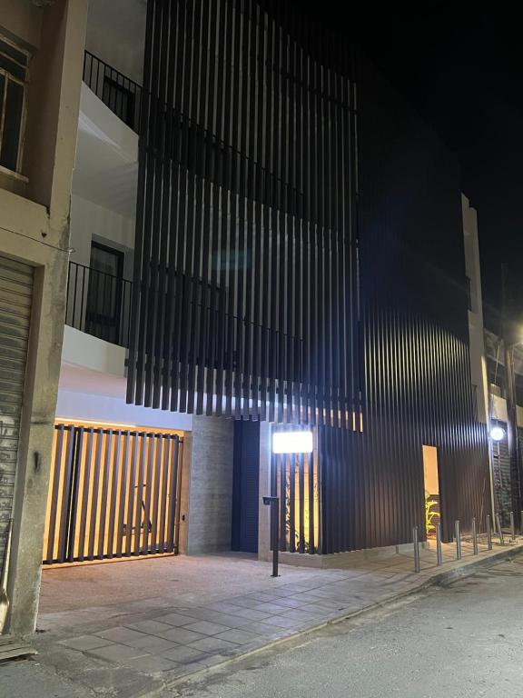a building with a gate and a parking meter at Alinea Market Agora Square in Limassol