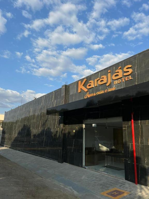 a building with a sign on the side of it at Karajas Hotel in Quixeramobim