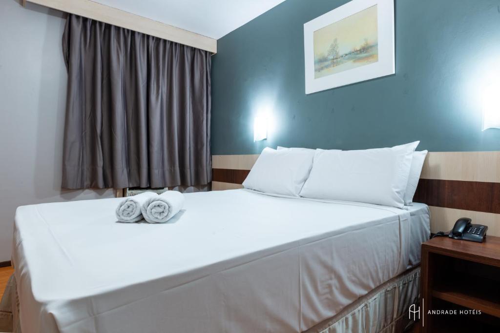 Postel nebo postele na pokoji v ubytování Rede Andrade Mercado Hotel
