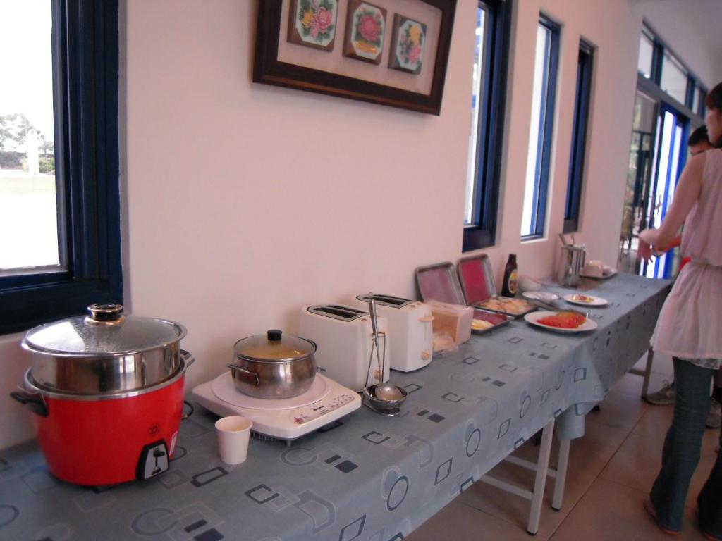 a buffet line with pots and pans on a table at Promised Land B&amp;B in Taitung City
