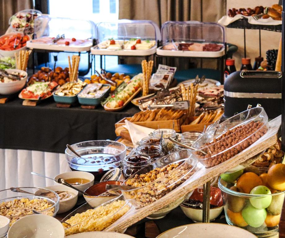 a buffet with many different types of food on a table at Amsterdam Hotel in Belgrade