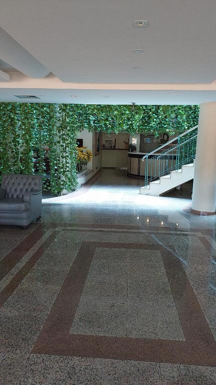 a large lobby with a wall of plants at Pousada dos Girassóis in Palmas