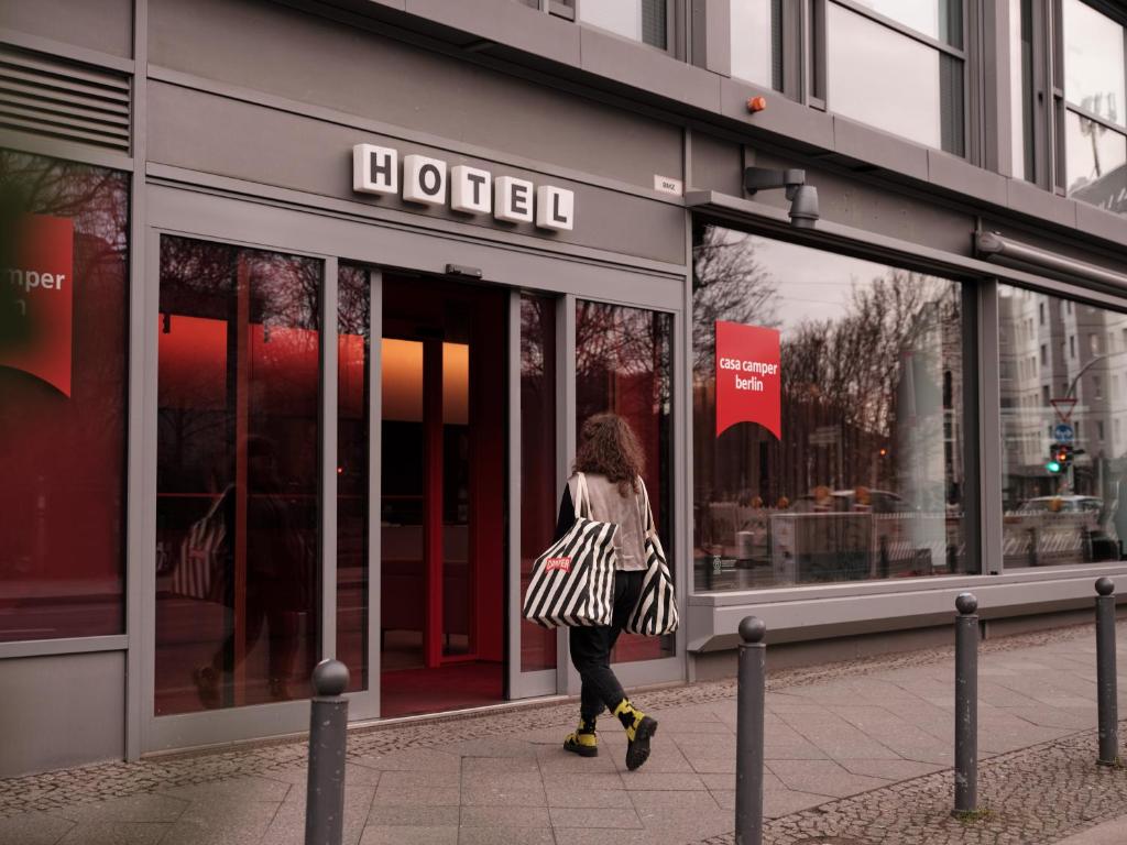 a woman walking in front of a store at Casa Camper Berlin in Berlin