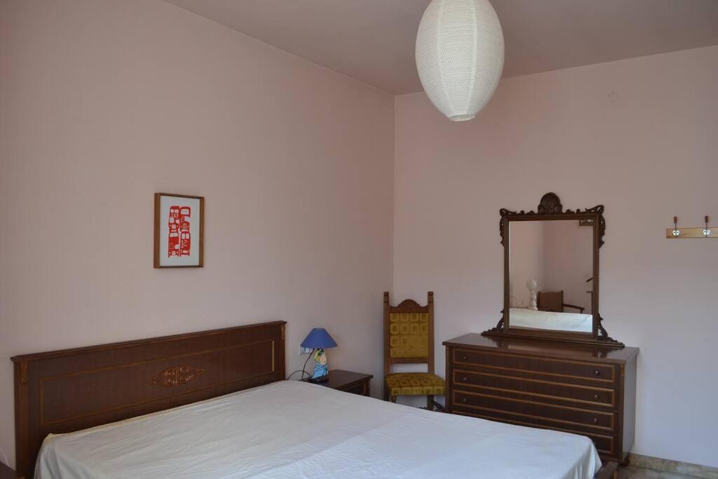 a bedroom with a bed and a dresser and a mirror at La marmotta gialla - apartment - lakes - mountains in Clusone