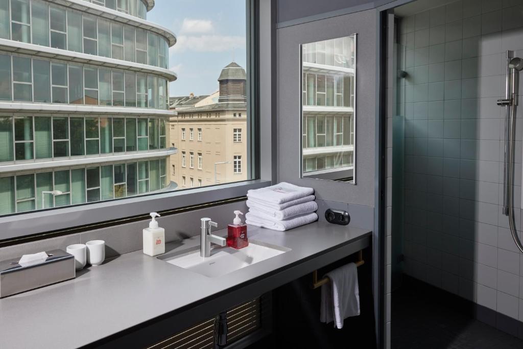 a bathroom with a sink and a window at Casa Camper Berlin in Berlin