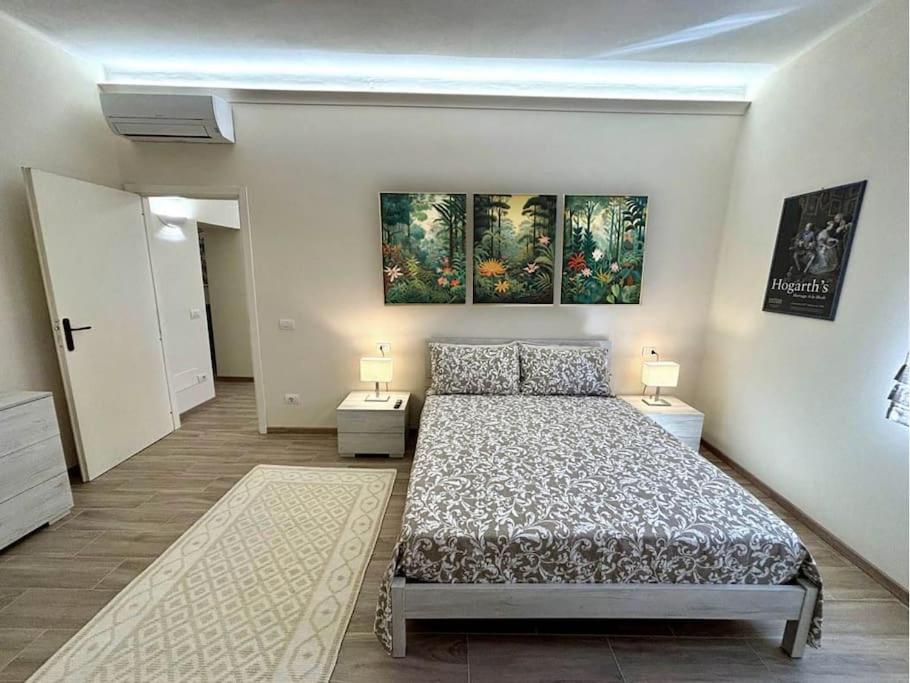 a bedroom with a bed and two lamps in it at A due passi da Piazza Cavalli in Piacenza