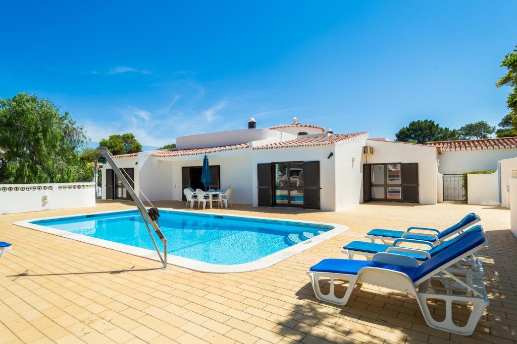 una villa con piscina di fronte a una casa di Casa dos Cães a Poço Partido